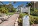 Community sign indicating the private beach access, surrounded by tropical plants and brick-paved pathways at 5807 Cay Cove Ct, Tampa, FL 33615