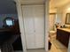 Bathroom featuring white closet doors, a vanity with granite top, and a toilet inside a shower/tub area at 601 N Hercules Ave # 403, Clearwater, FL 33765