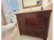 Bathroom featuring vanity with granite top, framed mirror, and toilet inside shower/tub area, with a closet door nearby at 601 N Hercules Ave # 403, Clearwater, FL 33765