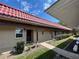 Inviting condo showcasing a terracotta roof, covered porch, and well-kept front yard landscaping at 601 N Hercules Ave # 403, Clearwater, FL 33765