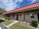 Charming condo featuring a terracotta tile roof, covered porch, and neatly maintained landscaping at 601 N Hercules Ave # 403, Clearwater, FL 33765