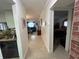 Hallway leading to the living area with tile floors, and view into the bedroom at 601 N Hercules Ave # 403, Clearwater, FL 33765