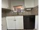 Classic kitchen design boasts white cabinetry, granite countertops, and dark appliances for a timeless appeal at 601 N Hercules Ave # 403, Clearwater, FL 33765