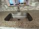 Kitchen sink and counter with a pass-through window, offering a view and connection to the adjacent room at 601 N Hercules Ave # 403, Clearwater, FL 33765
