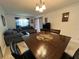 Open-concept living area featuring tile flooring, modern dining table, and comfortable seating at 601 N Hercules Ave # 403, Clearwater, FL 33765