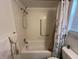 Shower and tub combo features tiled walls and stainless steel shower head at 601 N Hercules Ave # 403, Clearwater, FL 33765