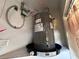 Home water heater with collection tray in utility closet at 601 N Hercules Ave # 403, Clearwater, FL 33765