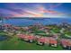 Stunning aerial view of the condo community with beautiful landscaping and water views during sunset at 6158 Palma Del Mar S Blvd # 406, St Petersburg, FL 33715