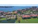 Aerial view of community located on the water, with tennis courts, parking, landscaping and bay view at 6158 Palma Del Mar S Blvd # 406, St Petersburg, FL 33715