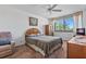 Comfortable bedroom featuring a queen bed, natural light, and carpet flooring at 6158 Palma Del Mar S Blvd # 406, St Petersburg, FL 33715