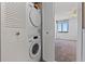 Stacked washer and dryer hidden behind white folding doors near a bedroom with carpeting, fan and window at 6158 Palma Del Mar S Blvd # 406, St Petersburg, FL 33715