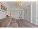 Carpeted living room with white walls, multiple storage closets, ceiling fan, couch and a large picture frame at 6158 Palma Del Mar S Blvd # 406, St Petersburg, FL 33715