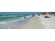 Beautiful view of the beach with people enjoying the clear turquoise water and white sand at 6265 Sun Blvd # 806, St Petersburg, FL 33715