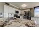 Well-appointed kitchen features white cabinetry, stainless steel appliances, and granite countertops at 6265 Sun Blvd # 806, St Petersburg, FL 33715
