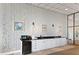 Common area kitchenette with white cabinets, black countertop, and stainless appliances at 6265 Sun Blvd # 806, St Petersburg, FL 33715