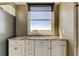 Kitchenette with granite counters, white cabinets, and window overlooking the bay at 6265 Sun Blvd # 806, St Petersburg, FL 33715