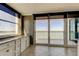 Bright kitchenette with granite counters, white cabinets, and sliding doors to balcony with water views at 6265 Sun Blvd # 806, St Petersburg, FL 33715