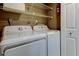 Convenient laundry room with washer, dryer, and storage shelves at 6265 Sun Blvd # 806, St Petersburg, FL 33715
