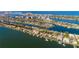 Breathtaking aerial view showcasing waterfront homes along canals, with a stunning cityscape in the background and ocean views at 670 Island Way # 806, Clearwater Beach, FL 33767