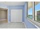 Cozy bedroom showcasing spacious closet, balcony, and light tile flooring at 670 Island Way # 806, Clearwater Beach, FL 33767