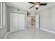 This bedroom features neutral walls, tile floors, a ceiling fan and a double closet at 670 Island Way # 806, Clearwater Beach, FL 33767