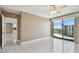 Spacious bedroom with tile floors, ceiling fan, and a sliding glass door to balcony at 670 Island Way # 806, Clearwater Beach, FL 33767