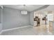 Open dining area with modern chandelier fixture open to a kitchen with stainless steel appliances and tile floors at 670 Island Way # 806, Clearwater Beach, FL 33767