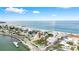 Aerial view showing the neighborhood with ocean views, pier and vacant lot at 702 Pass A Grille Way, St Pete Beach, FL 33706