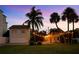 Backyard features palm trees and patio lighting, perfect for backyard gatherings at 702 Pass A Grille Way, St Pete Beach, FL 33706