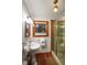 Bathroom featuring pedestal sink, glass enclosed shower and beautiful accent lighting at 702 Pass A Grille Way, St Pete Beach, FL 33706