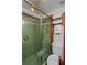 Bathroom featuring a walk-in shower with green tiling and matching green floor tiling at 702 Pass A Grille Way, St Pete Beach, FL 33706