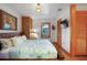 Nicely appointed bedroom featuring wood floors, panelled walls, a brick pillar, a queen bed, and a closet at 702 Pass A Grille Way, St Pete Beach, FL 33706