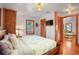 Tastefully decorated bedroom with hardwood floors, brick accent, and a view to another living space at 702 Pass A Grille Way, St Pete Beach, FL 33706