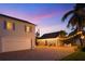 Well-maintained exterior with brick driveway, palm trees, and string lights at 702 Pass A Grille Way, St Pete Beach, FL 33706