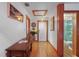 Hallway featuring wood trim, bead board walls and ceiling, wood floors, and view into bathroom at 702 Pass A Grille Way, St Pete Beach, FL 33706