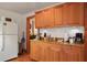 Charming kitchen with wooden cabinets, granite counters, and stainless steel appliances at 702 Pass A Grille Way, St Pete Beach, FL 33706