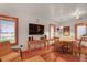 Cozy living room with hardwood floors, wooden trim, and large windows that provide ample natural light at 702 Pass A Grille Way, St Pete Beach, FL 33706