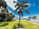 Beautiful waterfront property boasting lush green lawn and views of the open bay and sky at 702 Pass A Grille Way, St Pete Beach, FL 33706