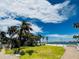 Beautiful waterfront property boasting lush green lawn and views of the open bay and sky at 702 Pass A Grille Way, St Pete Beach, FL 33706