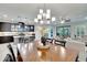 Dining area featuring a modern chandelier, that opens to a well-equipped kitchen and sunlit living room at 7211 Meeting House Ln, Apollo Beach, FL 33572