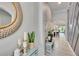 Inviting hallway featuring tile flooring, neutral walls, and stylish decor elements at 7211 Meeting House Ln, Apollo Beach, FL 33572