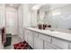 Bright bathroom features a double sink vanity with modern fixtures, a large mirror, and decorative accents at 7494 Pool Compass Loop, Wesley Chapel, FL 33545