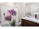 Bathroom featuring a decorative shower curtain with flower accents and a wood vanity at 7494 Pool Compass Loop, Wesley Chapel, FL 33545