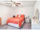 Cozy bedroom featuring a ceiling fan, an orange comforter and white and gray marble furniture at 7494 Pool Compass Loop, Wesley Chapel, FL 33545
