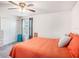 Comfortable bedroom featuring a ceiling fan, gray curtains and a white closet at 7494 Pool Compass Loop, Wesley Chapel, FL 33545