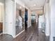 Inviting entryway features stylish wood floors, a decorative mirror, and a view into the living spaces at 7494 Pool Compass Loop, Wesley Chapel, FL 33545