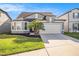 Charming single-Gathering home with a well-manicured lawn, beautiful landscaping, and a two-car garage at 7494 Pool Compass Loop, Wesley Chapel, FL 33545