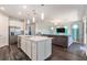 Contemporary kitchen with a center island, stainless appliances, and an open view of the Gathering room at 7494 Pool Compass Loop, Wesley Chapel, FL 33545
