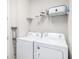 Functional laundry room is equipped with a side-by-side washer and dryer set at 7494 Pool Compass Loop, Wesley Chapel, FL 33545
