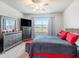 Serene main bedroom featuring a neutral color scheme, a large window, and ample closet space at 7494 Pool Compass Loop, Wesley Chapel, FL 33545